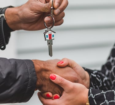 a man and woman shaking hands with keys