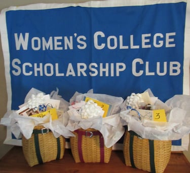 Women's college scholarship club sign with three pack basket raffle baskets