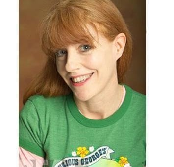 a woman with red hair and a green shirt