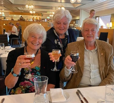 two women and one man toasting