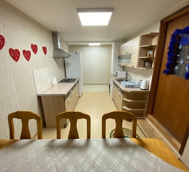 a kitchen with a table and chairs