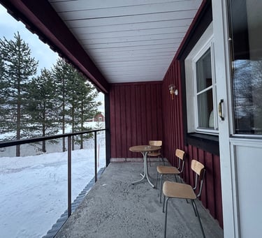 a balcony with chairs and tables