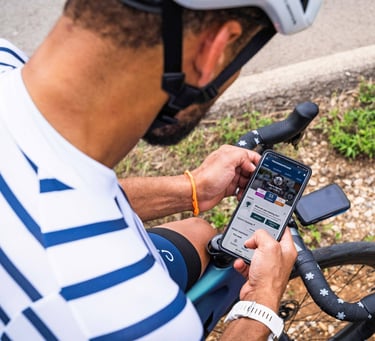 a cyclist reviewing a planned training session on their phone