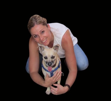 a woman holding a dog and smiling