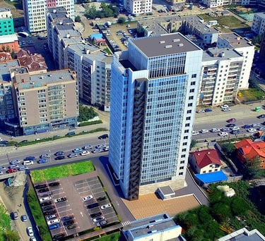 a city street scene with a large building in the background