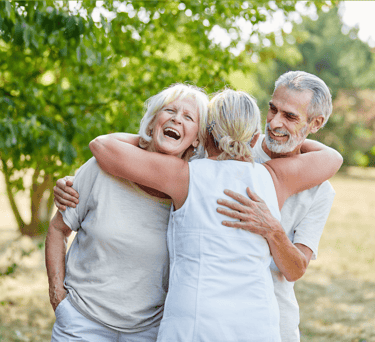A group of older adult friends hugging