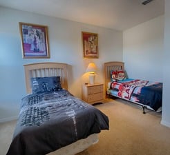 a bedroom with two twin beds and a lamp