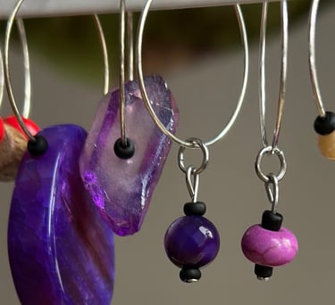 Rosevale Accessories handmade gemstone wine charms on jewelry display