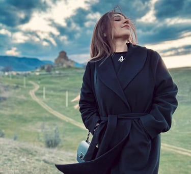 Maria Raza Sohni in a black coat and boots 