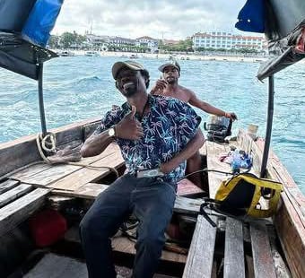 Smiling local Zanzibar tour guide on a boat trip with tourists to Prison Island (Changuu Island)
