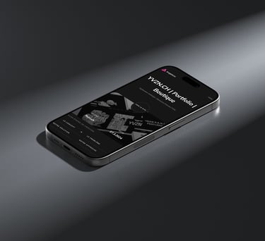 An iPhone displaying the YVZN website on its screen.