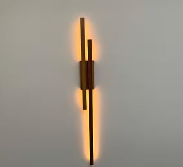 a wall mounted light fixture with a wooden wall