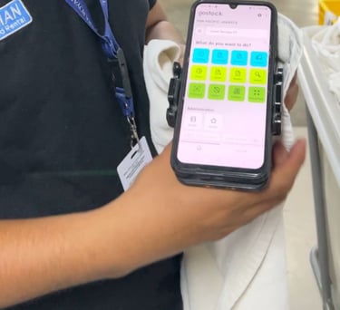 A staff member using a mobile inventory management app to track laundry in a facility.