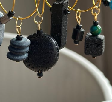 Rosevale Accessories handmade gemstone wine charms on jewelry display