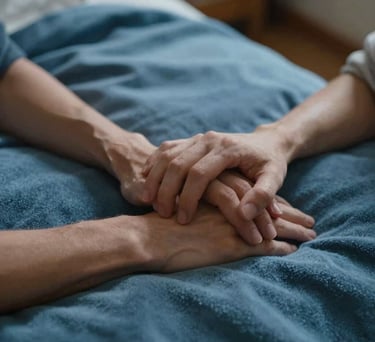 Close up of a couple's hands resting together on a soft blue blanket in a North American home, lighting suggesting a cozy, empathetic evening.