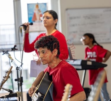 Students interacting with the elderly via music.