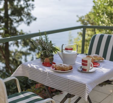 Cozy table and chairs on the apartment terrace with sea and Krk Island views