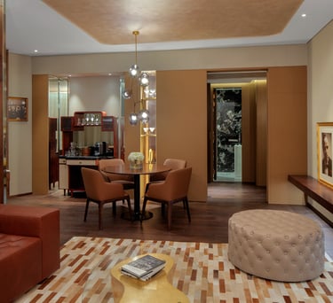 a living room with a couch, chairs, and a table