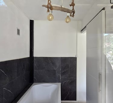 a bathroom with a tub and a chandelier