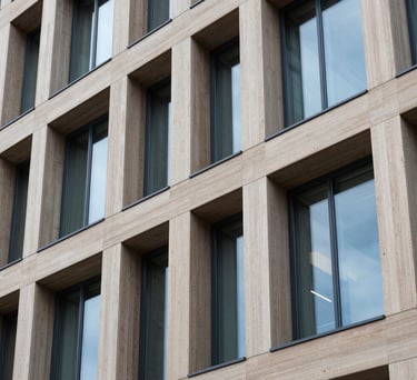A detail shot of modern office architecture in Northern Europe, focusing on clean lines, light wood, and blue-tinted glass, symbolizing structure and clarity.