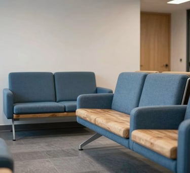 A serene photograph of a professional waiting area in a Danish office, featuring modern furniture in steel blue and natural materials, creating a welcoming and secure atmosphere.