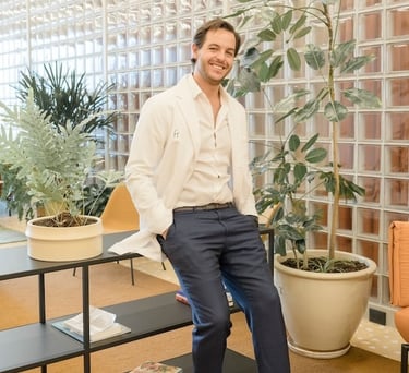 Fertility clinic specialist welcoming patients in a modern lounge area.