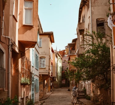 a sugar baby sitting on a bench in a city