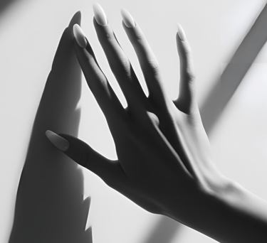 a woman's hand casting a shadow on a wall for step into your divine feminine coaching by LVFLVX.COM