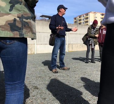 Andrew White At the Berlin Wall memorial talking about the Cold War and the division of Berlin