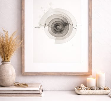 Framed minimalist abstract spiral art print on a white sideboard with candles and dried pampas grass.