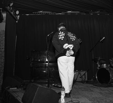 zachary booth on stage at the hotel cafe