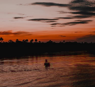 a couple of people in a boat on a river