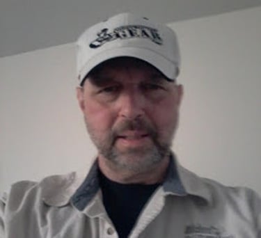 a man in a white shirt and a white hat