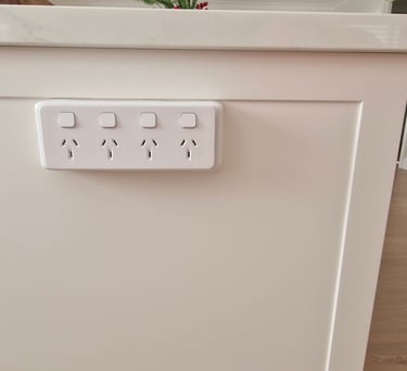 a white quad power point on the side of an island bench