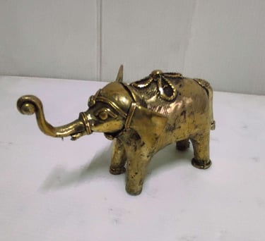 "Handcrafted shiny brass baby elephant with tribal engravings, left side view-Going abroad"