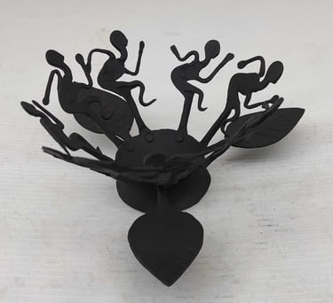 "Handcrafted tribal iron oil lamp with dancing figures–front view–for international delivery"