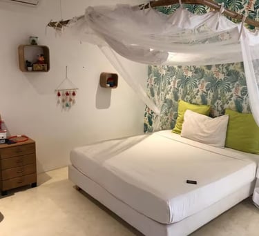 a bed with a canopy bed and a white bed