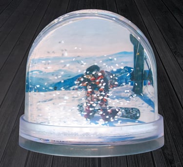 a snow globe with a snowboarder in the middle of it