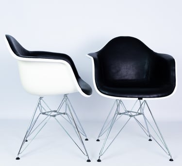 White and black plastic Eames chairs with metal legs – modern designer chairs