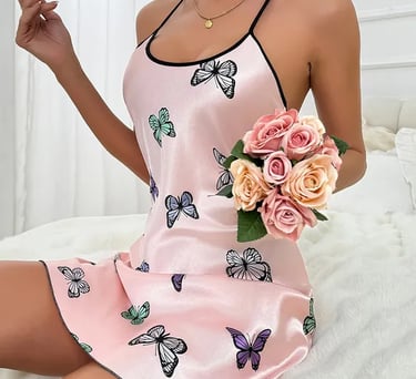 a woman in a pink dress holding a bouquet of roses
