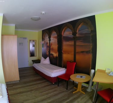 a bedroom with a bed and a desk