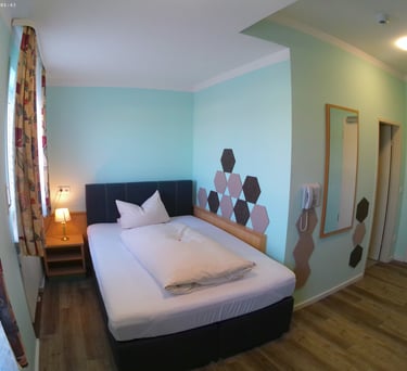 a bedroom with a bed and a bed in the corner