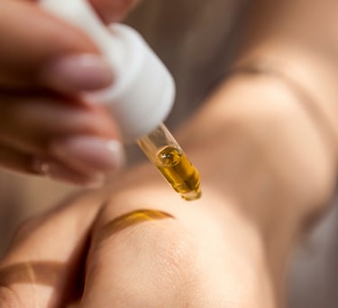 Applying oil with a dropper pipette to hand
