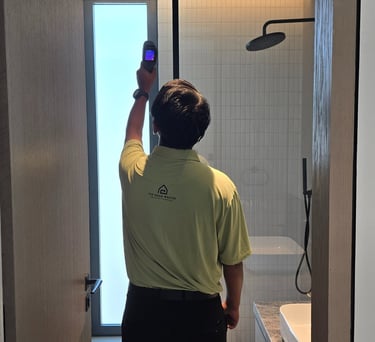 Engineer inspecting with thermal camera for leaks during villa inspection
