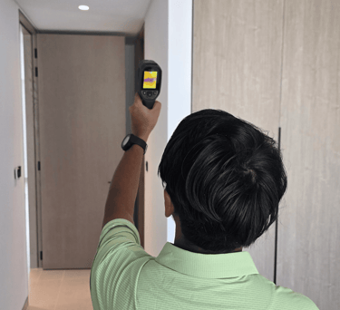Engineer inspecting with thermal camera for leaks during villa inspection