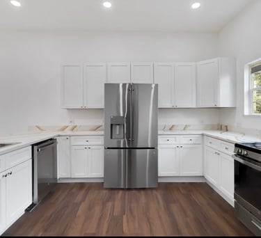 Custom kitchen featuring stainless steel fridge and modern cabinetry