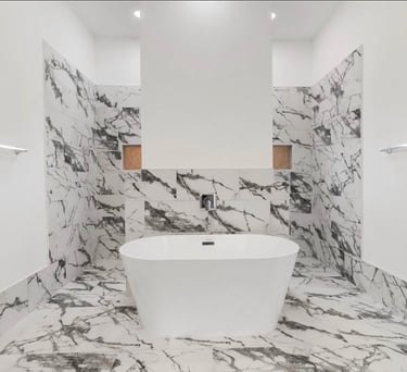 Modern soaking tub with separate vanities in primary bathroom