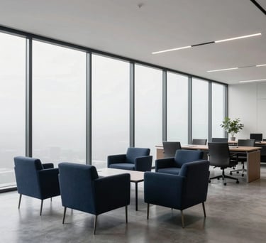 A wide-angle photograph of a clean, minimalist professional office space in North America with floor-to-ceiling windows and simple navy and charcoal furniture.