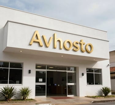 The entrance of the Avhsto headquarters in the Bela Vista neighborhood of Teófilo Otoni, a clean white building with professional gold signage, welcoming South American atmosphere.