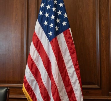 Close-up of a high-quality American flag standing in a wood-paneled federal office, soft natural light, North American / US setting.
